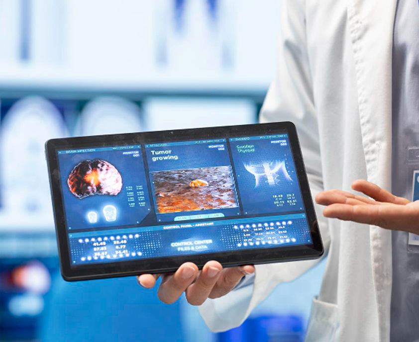 Clinician holding a tablet displaying a medical scan