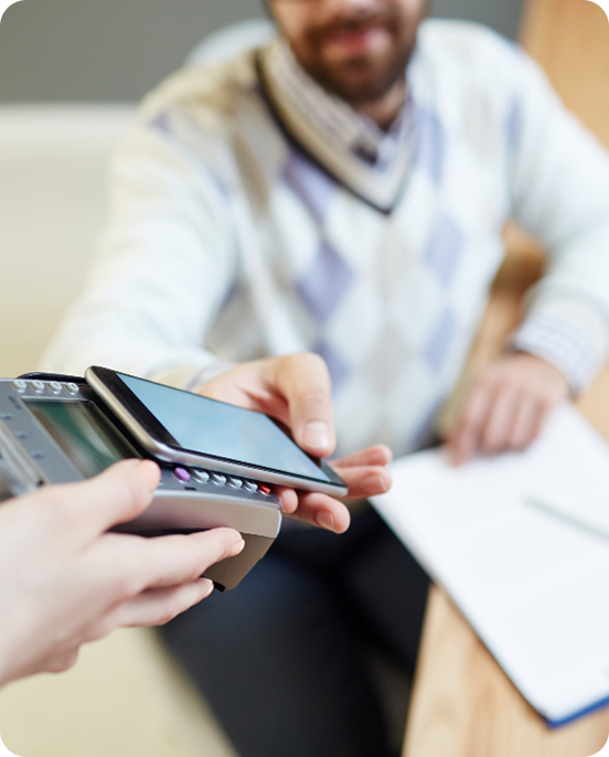 Patient checking their phone while holding a tablet