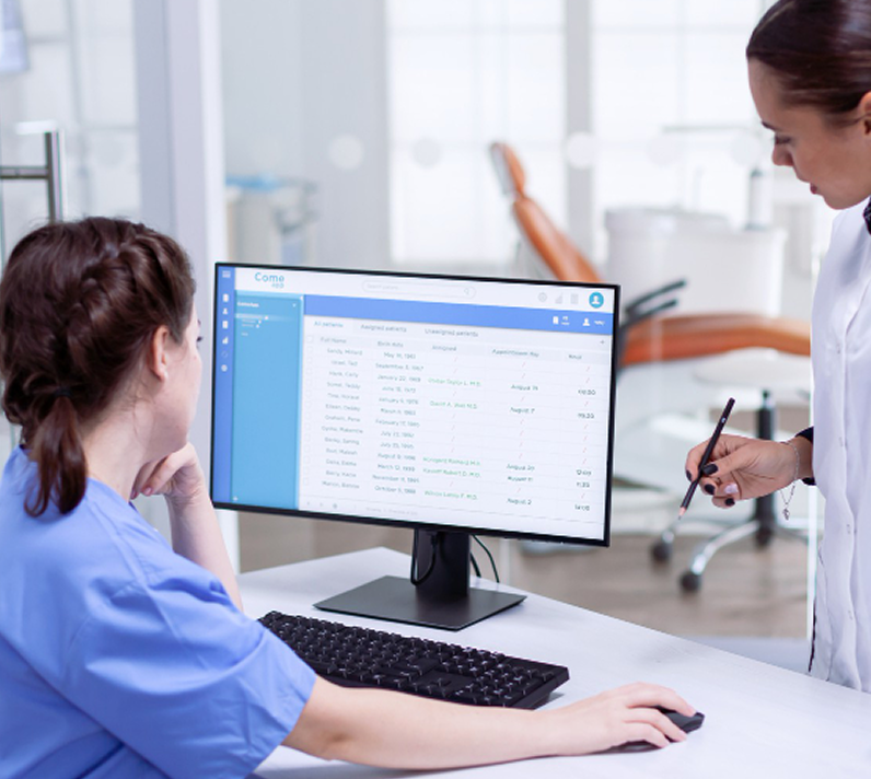 Clinician reviewing patient information on a desktop monitor